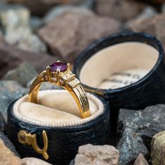 This pretty ring is centered with one (1) cushion cut natural ruby set into a four-prong setting. The shoulders of the ring are each accented with four (4), bead set, round brilliant cut diamonds. The ring measures 5.9mm at the top, rises 5.1mm above the finger, tapering to 2.1mm wide and 0.7mm thick at the base of the shank. This ring is currently a size 6. There is a tiny nick on the ruby but nothing noticeable that distracts from its beauty. Luxury Ruby Rings With Gemstone Accents, Luxury Ruby Diamond Ring With Accent Stones, Luxury Ruby Ring With Gemstone Accents For Anniversary, Luxury Ruby Ring With Round Cut Gemstone, Luxury Ruby Ring With Center Stone For Anniversary, Luxury 14k Gold Ruby Ring With Gemstone Accents, Luxury Ruby Jewelry With Accent Stones, Elegant Cushion Cut Ruby Ring In Yellow Gold, Heirloom Lab-created Ruby Jewelry In Round Cut