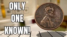 a penny sitting on top of a wooden table next to the words, only one known