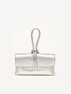 The bag of the season is here. The Francesca is a convertible clutch that's simple, elegant, and undeniably fun. Loop the tubular strap around your wrist and keep your hands free (for a glass of Prosecco, perhaps?). Hilary Banks, Wedding Guest Attire, Silver Clutch, Wedding Purse, Handbag Collection, Guest Attire, Metallic Foil, Metallic Leather, Leather Clutch