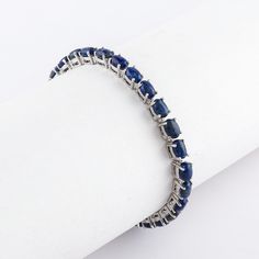 Experience the allure of elegance with our **Blue Sapphire Tennis Bracelet**. Handcrafted with love and precision, this exquisite piece of jewelry is more than just an accessory. It's a statement of sophistication, a testament to timeless fashion. Made with **925 fine silver this bracelet is the perfect anniversary gift that will make her feel truly special. ## Key Features - **Stunning Blue Sapphire Each bracelet features a series of carefully selected blue sapphires, known for their vibrant co Sapphire Sterling Silver Bracelet, Formal Sapphire Sterling Silver Gemstone Bracelet, Sapphire Bracelets With Prong Setting For Anniversary, Elegant Sapphire Sterling Silver Bracelet As Gift, White Gold Sapphire Bracelet As Gift, Classic Silver Sapphire Bracelets, Luxury Sapphire Bracelets For Anniversary, Classic Sapphire Bracelets For Anniversary, Elegant Blue Bracelet With Sterling Silver Clasp