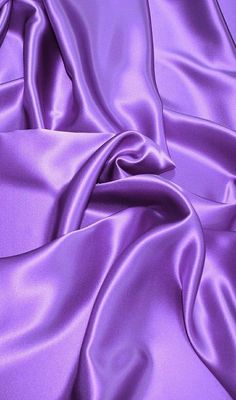 a close up view of a purple satin fabric