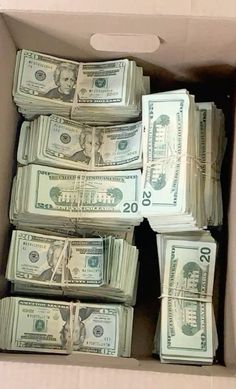 a box filled with lots of money sitting on top of a table