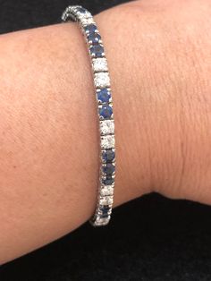 Set your eyes on this gorgeous and elegant vintage platinum cornflower blue sapphire and diamond tennis bracelet. The cornflower blue sapphires weigh approximately 5 carats. The diamonds weigh approximately 3 carats. The diamonds are VS-SI clarity and G-H color. This piece, circa 1950s, weighs 12.11 grams and is 7 inches long. Platinum Jewelry With Blue Single Cut Diamonds, Blue Single Cut Diamond Jewelry In Platinum, Blue Platinum Jewelry With Single Cut Diamonds, Formal Blue Platinum Bracelet, Classic Blue Cubic Zirconia Tennis Bracelet, Blue Diamond Platinum Bracelet For Formal Occasions, Blue Diamond Jubilee Tennis Bracelet, Formal Blue Diamond Platinum Bracelet, Classic Sapphire Tennis Bracelet With Prong Setting