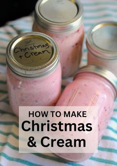 three mason jars filled with christmas and cream on top of a striped table cloth next to each other