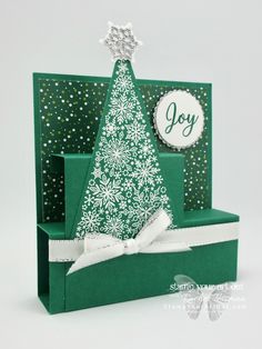 a card with a christmas tree on it and the word joy is written in white