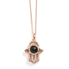 Introducing our Personalized Hamsa Necklace, a unique accessory that blends tradition with personal storytelling. This necklace features a Hamsa pendant, a symbol of protection and good fortune, designed to hold a special photo inside. It's not just a piece of jewelry; it's a personal talisman that keeps your cherished memories close to your heart. Perfect for everyday wear or as a meaningful gift, this necklace adds a personal touch and a layer of significance to your style, ensuring that what' Rose Gold Medallion Amulet Jewelry, Rose Gold Medallion Necklace In Amulet Style, Rose Gold Medallion Amulet Necklace, Rose Gold Pendant Medallion Necklace As Gift, Rose Gold Medallion Pendant Necklace As Gift, Rose Gold Jewelry With Large Pendant As Gift, Good Luck Amulet Jewelry With Round Pendant, Symbolic Pendant Locket Jewelry, Spiritual Oval Pendant Necklace For Gifts