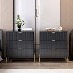 two black dressers with gold handles in a room