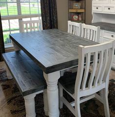 a dining room table with chairs and a bench