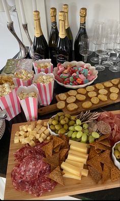 an assortment of snacks and wine on a table