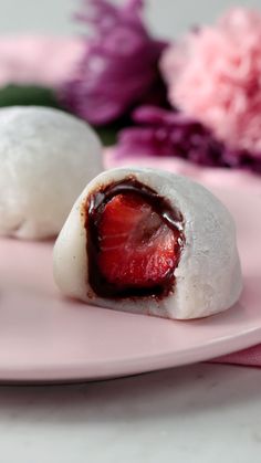 two desserts on a pink plate with flowers in the background