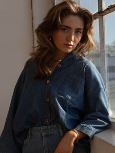 Meet our best-selling Linen Shirt, now in soft, denim chambray! This relaxed-fit button down-shirt for women has wide sleeves and a boxy fit that makes it the perfect everyday piece for the warm weather. We love it paired with The Chambray Denim Short or The Wide Leg Jean.Our small-batch wash process means that each of our denim garments will vary slightly in color and appearance.• Composition: 100% cotton• Available in: MID DENIM• US sizes: XS (US 0–2), S (US 4–6), M (US 8–10), L (US 12–14), XL Trendy Medium Wash Denim Top, Trendy Medium Wash Denim Top For Everyday, Relaxed Fit Denim Blouse With Pockets, Relaxed Fit Everyday Tops Made Of Tencel, Everyday Relaxed Fit Tencel Tops, Denim Top For Casual Gatherings With Relaxed Fit, Relaxed Fit Washed Blue Chambray Denim Top, Washed Blue Relaxed Fit Blouse, Casual Relaxed Fit Denim Top Made Of Tencel