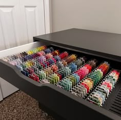 a black piano with many different colored pens in it