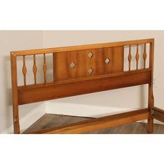 a wooden headboard and foot board in a room