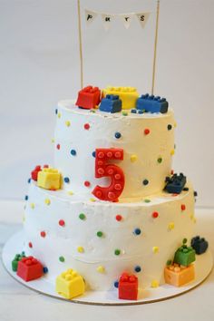 a three tiered cake with legos on it