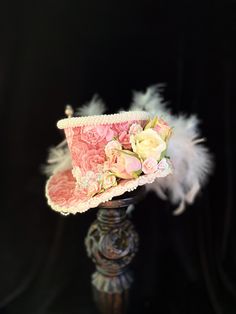 Flowers, feathers and pearls oh my!! This mini top hat has it all and more. This little gem is a one-of-a-kind design and will add a touch of Country French elegance to your mannequin, shop display or worn as a fascinator. This hat is made on a foam base so it is lightweight yet durable. This beauty measures approximately If you are wanting to wear this mini top hat as a fascinator please indicate whether you prefer black or white elastic attached. Also include a measurement of your head from cr Mad Hatter Outfit, Baby Party Ideas, Hat With Flowers, Steampunk Stuff, Lace Hat, Tea Hats, Mini Hats, French Elegance, Mini Top Hat