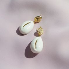 As a fashionable element, cowrie shells have a very long history of body jewellery. Today we want to offer you something a bit different. These teardrop cowrie shaped shells are made of white porcelain and are perfect for your beach outfit. You can pair them with every style, from swimsuit to evening dress.MATERIALHandmade porcelain cowrie shellsGold-plated metal925 Sterling silver earring posts Gold- or silver-plated colour will fade over time. This is a normal result from long-term wear and co Soap Perfume, Hand Cleaning, Chemical Products, Cowrie Shells, Handmade Porcelain, Cowrie Shell, Earring Posts, Long History, Body Jewellery