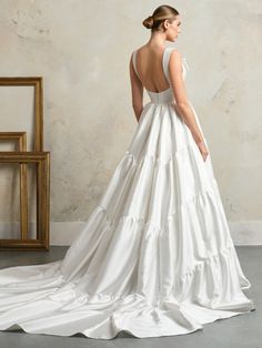 a woman in a white wedding dress looking back