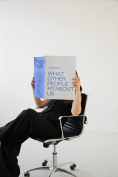 a woman sitting in an office chair holding up a sign that reads what other people us about