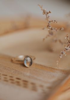 Our Dori ring is made with a gorgeous Labradorite stone. This mystical gemstone is believed to enhance mental clarity and bring about transformation. It's a crystal connected to the third eye chakra which is our gateway to inner wisdom and deeper intuition. 8mm round or 6x8mm oval labradorite stone. Ring band measures 1mm wide. Available in 14kt Gold Fill + Sterling Silver. Juliann stacks it with our Swell Ring and 2 Confetti Rings. KJ pairs it with our Sonder Ring, Raye Ring, and Confetti Ring. Adjustable Oval Untreated Moonstone Ring, Adjustable Untreated Oval Moonstone Ring, Anniversary Rings With Natural Inclusions, Oval Cabochon Shape, 14k Gold Rings With Natural Inclusions For Gift, Oval Cabochon Ring With Natural Inclusions For Gift, Oval Labradorite Promise Rings, Anniversary Jewelry With Natural Inclusions In Oval Shape, Elegant Oval Moonstone Ring With Natural Inclusions, Oval Labradorite Wedding Jewelry