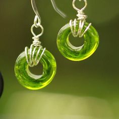 These large-holed ring beads are a simple and elegant choice! The glass bead captures light in a beautiful and incredibly unique way. This particular color is inspired by the natural green olivine mineral that is responsible for Hawaii's famous green-sand beach.  Each glass bead is melted and crafted by hand here in Kona, Hawaii. I began making glass beads and earrings at the age of 11 and my love for hand arts has only grown since! These earrings capture the island, ocean, and Aloha spirit. Ple Hypoallergenic Green Glass Jewelry, Recycled Glass Spacer Beads Jewelry For Jewelry Making, Recycled Glass Spacer Beads For Jewelry Making, Recycled Glass Jewelry With Spacer Beads As Gift, Spacer Beads Jewelry With Recycled Glass For Jewelry Making, Green Wire Wrapped Czech Glass Jewelry, Recycled Glass Spacer Beads Jewelry As Gift, Green Recycled Glass Bead Jewelry, Green Recycled Glass Round Bead Jewelry