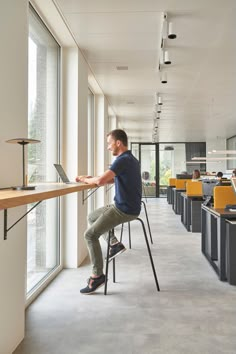 a man sitting at a desk using a laptop computer