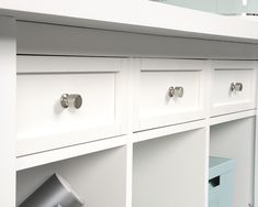 a white cabinet with drawers and knobs on it