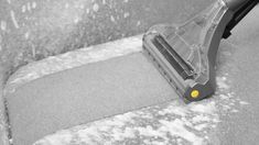 a black and white photo of a snow covered floor with a dust mop on it