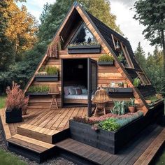 a small wooden cabin in the middle of some trees and plants on top of it