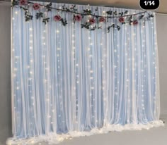 the curtains are decorated with lights and roses on them, along with snow flakes