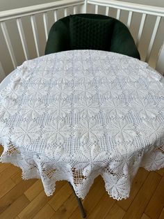 a white table cloth on top of a green chair