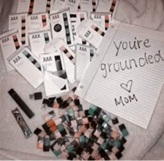 there are many cards and pens on the bed with writing that says, you're grounded mom