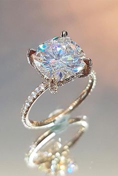 an engagement ring with a cushion cut diamond