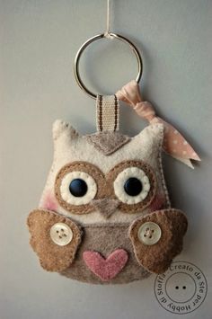 an owl keychain hanging on the wall