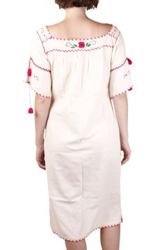 A cream cotton maxi day dress, is hand-embroidered with pink flowers and exposed stitching, and tasseled trumpet sleeves. Wear this dress everyday, to the farmers market, running errands, or out to lunch. This perfect summer vintage Mexican dress is light weight, and in fabulous condition. Product Measurements: See the Measurement Guide in the photo carousel. Shoulder: 19" Chest: 40" Waist: 28" - 32" Bum: 42" Sleeve Length: 10.5 Entire Length: 46" Condition: AB See the Condition Grade Scale on t Spring Folk Style Dress With Tassels, Spring Peasant Embroidered Dress With Hem Detail, Spring Peasant Dress With Embroidered Hem, Spring Peasant Embroidered Dress With Embroidered Hem, Spring Peasant Style Embroidered Dress, Spring Folk Style Cotton Embroidered Dress, Cream Folk Dress For Spring, Folk Style Cream Dress For Spring, Traditional Cream Dress For Spring