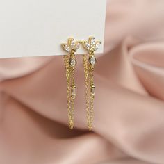 The pair you'll reach for again and again. Add a touch of sparkle to your life with these shimmering gems, designed to complete any look. Handcrafted with a sterling silver base, 14k gold plating and cubic zirconia, these earrings are truly one of a kind. Measuring 40mm in height, they are the perfect accessory to dress up any outfit. Whether you're heading to a party or just running errands, these earrings will add a touch of elegance to your day. Glamorous Cubic Zirconia Crystal Earrings As Gift, Gold Drop Diamond Earrings For Gift, Gold Plated Diamond Earrings As Gift, Dazzling Cubic Zirconia Chandelier Earrings As Gift, Glamorous Cubic Zirconia Earrings With Diamond Accents, Glamorous Cubic Zirconia Drop Earrings, Chandelier Earrings With Diamond Accents As Gift, Luxury Dangle Crystal Earrings, Cubic Zirconia Chandelier Earrings With Diamond Accents As Gift