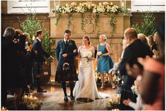 a bride and groom walk down the aisle at their wedding ceremony in front of guests