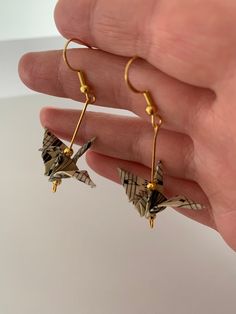 a pair of origami cranes dangling from gold earwires