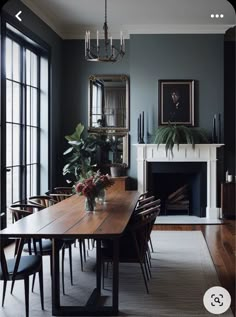 a dining room table with chairs and a fireplace