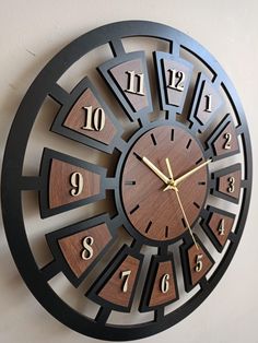 a clock that is on the wall and has numbers in all directions to indicate it's time