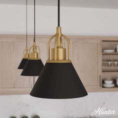 three black and gold pendant lights in a kitchen