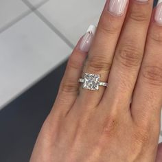 a woman's hand with a ring on it and a diamond in the middle