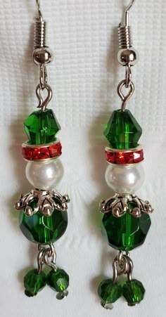 "A pair of Wiggley Elves are hand crafted on to each earring. These earrings are made with crystal and glass beads, strung on stainless steel , and attached to hypoallergenic, fish hook, ear wires. They measure \"approximately\" 1-1/2\" long from ear hole to the bottoms. EXTREEMELY Lightweight!  They are attached to a ready-hang card for display or gift giving. Ready to ship immediately!" Christmas Dangle Earrings, Christmas Earrings Handmade, Elf Earrings, Santa Earrings, Christmas Jewelry Diy, Christmas Beading, Diy Earrings Easy, Homemade Earrings, Diy Wire Jewelry