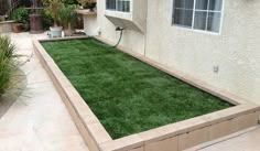 an empty backyard with grass in the middle