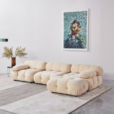 a living room with a large couch and a painting on the wall above it's head