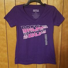 Womens Short Sleeve Graphic T Shirt Back To The 80s Vneck Cotton Polyester Blend Small Pit To Pit Across Roughly 17" Top Of Collar To Bottom Roughly 24" 90s Graphic Print Purple Top, 90s Purple Top With Graphic Print, 90s Style Purple Top With Graphic Print, Retro Purple Short Sleeve Top, Purple Short Sleeve 90s Tops, 90s Style Purple Short Sleeve Tops, 90s Style Fitted Purple Top, Fitted 90s Style Purple Top, Fitted Purple Top In 90s Style