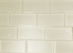 a close up view of a white tile wall