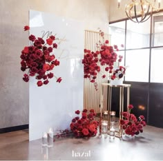 red flowers and candles are on display in front of a white sign with the word love written on it