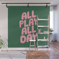 a green wall with pink lettering that says, all play all day on the side