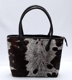 Splendid Lady Hand Bag of Natural Cowhides Absolutely one-of-a-kind, is one of those bags you don't ever want to leave home without. Handcrafted from very finest cowhide, Bag is sumptuous and unique, hand-selected hide and beautiful patterning. And with an abundance of space, it can take whatever you choose to throw at it - your laptop, an extra pair of flats, that stack of post you've been meaning to send. With this stunning cowhide bag on your arm (or slung over your shoulder - you're ready fo Cowhide Bag, Corner Protectors, Calgary, Leather Shoulder Bag, Leather Bag, Handbags, Shoulder Bag, Tote Bag, Leather