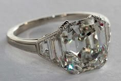 an old cut diamond ring on a white surface